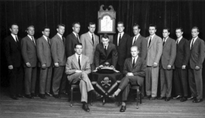 George H.W. Bush and his fellow bonesman. (Bush standing to the left of the clock).