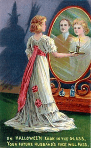 20th century Halloween greeting card showing the mirror ritual where a woman might catch a glimpse of her future husband.