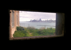 View of San Francisco from a tiny window in Alcatraz. Courtesy of Ali ChehadE/Getty.